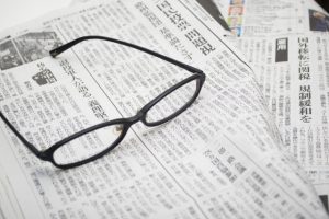 A newspaper and glasses